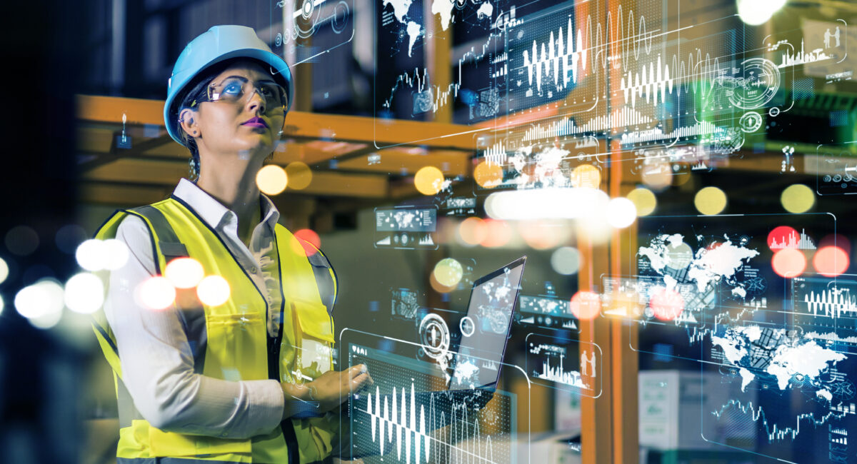 Women in high vis stood in production line looking at lights