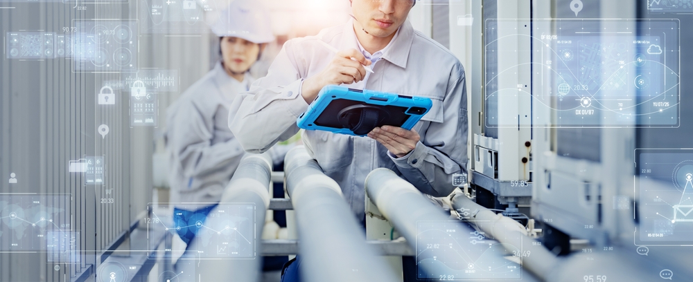 people in a manufacturing plant with an ipad